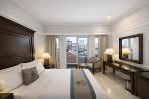 En eller flere senge i et værelse på Anphan Hotel & Spa - Ben Thanh Market