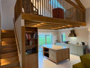a kitchen with a staircase leading up to a loft at Cluain Alainn in Cashel