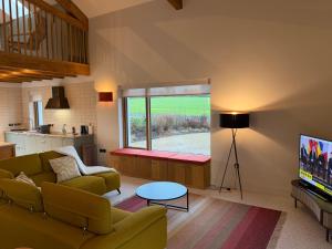 a living room with a couch and a tv at Cluain Alainn in Cashel