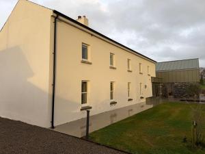 a large white building with a yard in front of it at Cluain Alainn in Cashel