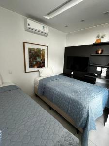 En eller flere senge i et værelse på Luxuoso Flat particular ATHOS BULCÃO