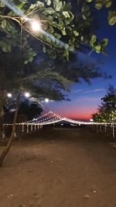 a view of a fence with lights at night at Chaitanya Beach Reesort in Dapoli