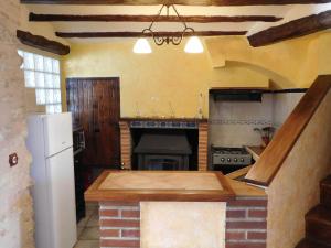 a kitchen with an island in the middle of it at Casa Rural Casa Gimeno in Bocairent +65 photos