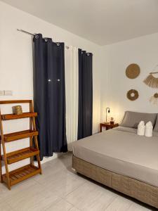 a bedroom with a bed and black curtains and a ladder at Gym house in San Vicente