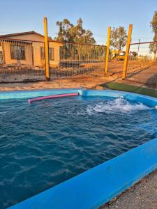 a pool of water with two poles in the water at Hermosa Cabaña en medio de la naturaleza in Los Angeles