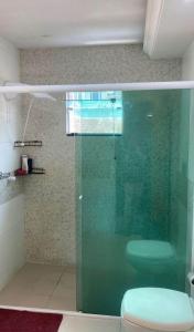 a bathroom with a glass shower with a toilet at Quarto Privado Próximo as Praias de Itajaí in Itajaí +19 photos