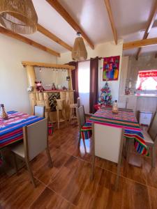 a dining room with two tables and a christmas tree at Hostal Inti Wasi in San Pedro de Atacama