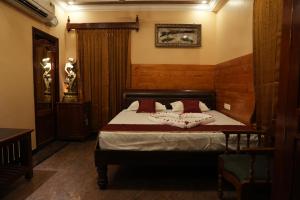 a bedroom with a bed with red pillows at SK Grand Palace in Pondicherry