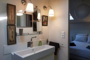 a bathroom with a sink and a bed at la chaume st martin in Angoulême