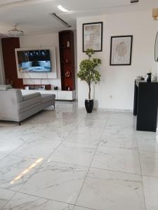 un soggiorno con un grande pavimento in marmo bianco di Mandys Guest House a Yaoundé