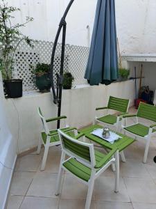 a table and chairs and an umbrella on a patio at Central Tangier , 3xBedroom , Apartment, Historic Medina, Margarita in Tangier