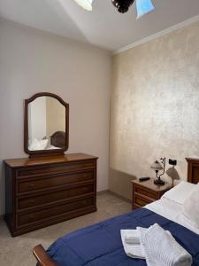 a bedroom with a bed and a mirror on a dresser at Il ciliegio in Chiavari
