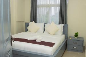 En eller flere senge i et værelse på The Reach Apartments