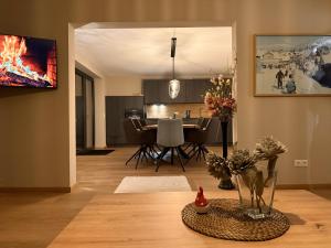 a living room with a table and a dining room at Bergflamme - Ihr Ferienhaus im Harz mit Panoramasauna in Braunlage