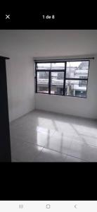 an empty room with a window and a tiled floor at Casa estrella in Manizales