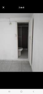 a bathroom with a toilet in a white room at Casa estrella in Manizales