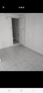 an empty room with a white floor and a door at Casa estrella in Manizales