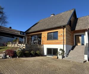 a house with a brick driveway in front of it at Bergflamme - Ihr Ferienhaus im Harz mit Panoramasauna in Braunlage