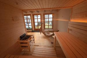 an inside view of a wooden cabin with a stove at Bergflamme - Ihr Ferienhaus im Harz mit Panoramasauna in Braunlage
