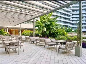 a patio with tables and chairs and a building at Concepcion Live in Buenos Aires