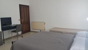 ein Schlafzimmer mit einem Bett und einem Schreibtisch und einem Schreibtisch in der Unterkunft La casa del capitano in Tarquinia