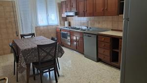 eine Küche mit einem Tisch und einem Tisch und Stühlen in der Unterkunft La casa del capitano in Tarquinia