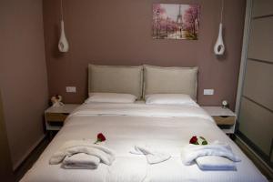 a bedroom with a bed with towels on it at Elpida's Retreat, Pelion in Tsagarada