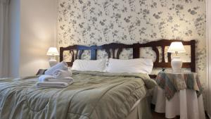a bedroom with a bed with towels on it at Gran Hotel Mar del Plata in Mar del Plata