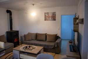 a living room with a couch and a table at Elpida's Retreat, Pelion in Tsagarada