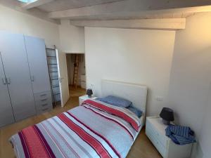 a small bedroom with a bed and a closet at La Piccola Perla di Rovereto in Rovereto