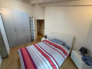 a bedroom with a bed and white cabinets at La Piccola Perla di Rovereto in Rovereto