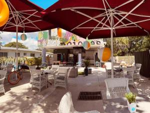 a patio with tables and chairs with umbrellas at Atrium Star Wars-themed Design District in Miami