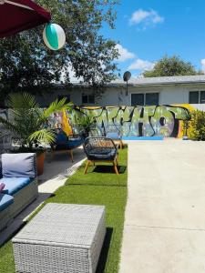 a yard with chairs and a playground with graffiti at Atrium Star Wars-themed Design District in Miami