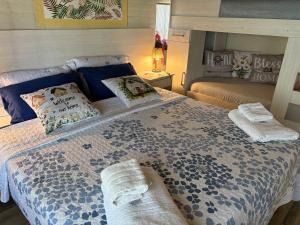 a bedroom with a large bed with towels on it at Apart Los Cerrillos in Balcarce +45 photos