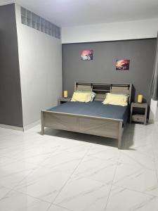 a bedroom with a bed with blue sheets and yellow pillows at Studio One in Port Louis
