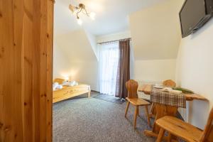 Schlafzimmer mit einem Schreibtisch und einem Tisch mit einem Stuhl in der Unterkunft Skalny Brzeg in Czarna Góra