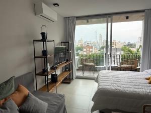 une chambre avec un lit et un balcon dans l'établissement Departamento Estudio Deluxe, à La Plata