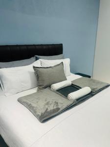 a white bed with pillows and a tray on it at RT Guest House in Walvis Bay