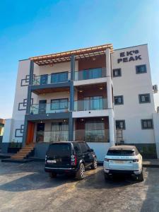 two vehicles parked in front of a building at EK'sPEAK in Kumasi