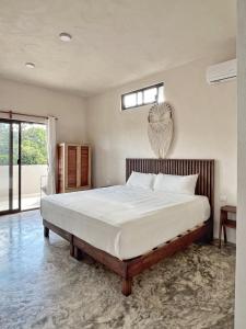 a bedroom with a large bed and a window at Hotel Lydna Ki'n in Bacalar +56 photos