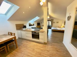 a kitchen with a sink and a stove top oven at Gästehaus Florian in Grainau