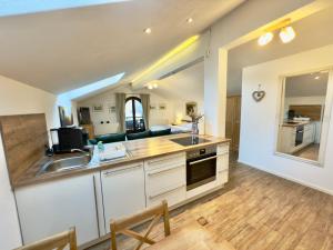 a kitchen with a sink and a counter top at Gästehaus Florian in Grainau +2 photos