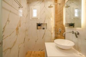 a bathroom with a sink and a shower at Kokkinia Gardens in Kavos +45 photos