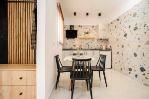 a kitchen with a table and chairs in a room at Kokkinia Gardens in Kavos