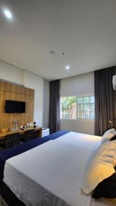 Ένα ή περισσότερα κρεβάτια σε δωμάτιο στο Granja Brasil puc 10 2