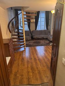 a room with a staircase and a living room at Квартира in Chişinău