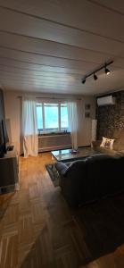 a living room with a couch and a large window at Villa Kjell in Vidsel