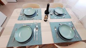 een tafel met blauwe platen en zilverwerk erop bij Cosy Vau in Vau +2 foto's