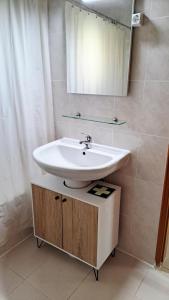 een badkamer met een wastafel en een spiegel bij Cosy Vau in Vau