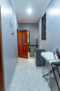 Habitación con silla, mesa y puerta en Global Apartments, en Jinja